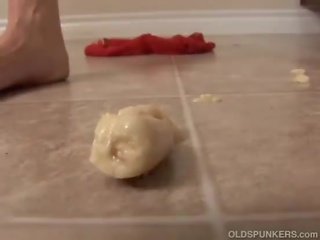 Mature redhead plays with food